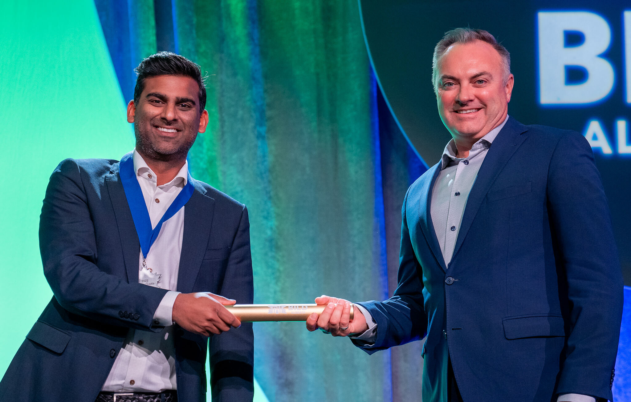 Past Chair Dhruv Gupta passes the baton to New Board Chair Chris Plosz at the 2023 Beyond Conference on on September 16 in Banff, Alberta.